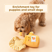 Small dog sniffing out treats from the apricots of the opened toy. Text: Enrichment toy for puppies and small dogs